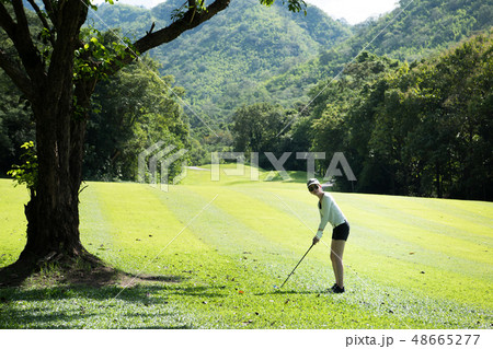 Asian woman playing golf on natural golf course 48665277