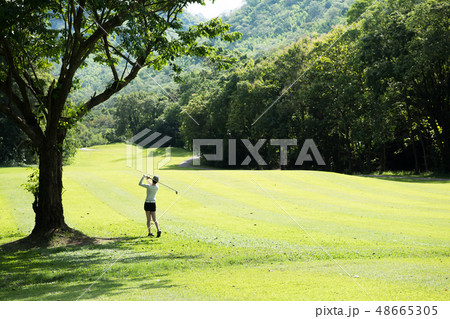 Asian woman playing golf on natural golf course 48665305