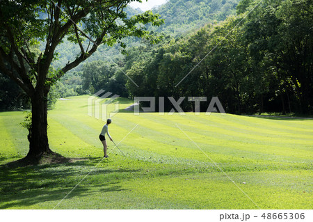 Asian woman playing golf on natural golf course 48665306