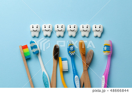 Healthy white teeth are smiling on blue background with toothbrush 48666844