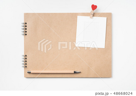 kraft notebook, photo frame and pen on white kraft notebook, photo frame and pen on white 48668024