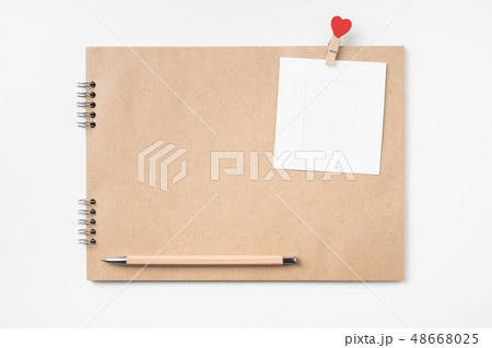 kraft notebook, photo frame and pen on white kraft notebook, photo frame and pen on white 48668025