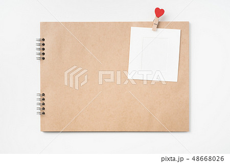 kraft notebook, photo frame and pen on white kraft notebook, photo frame and pen on white 48668026