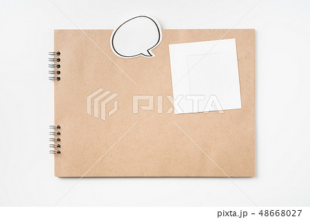 kraft notebook, photo frame and pen on white 48668027