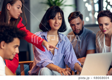 Teamwork concept.Young creative coworkers working with new startup project in modern office.Group of 48668604