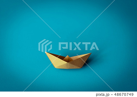 yellow paper boat on bright background 48670749