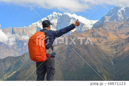 Young trekker looking at snow mountain Young trekker looking at snow mountain 48671123