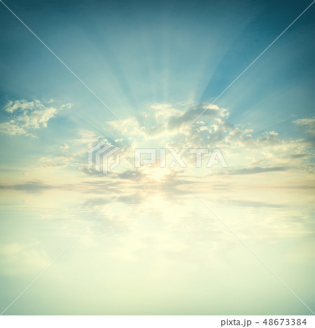 Sky with clouds and sun reflection in water 48673384