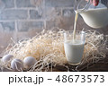 Pouring milk and eggs 48673573
