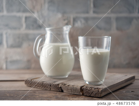 Milk in a glass and jug 48673576
