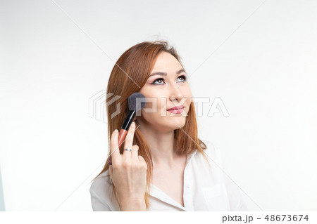 Beauty makeup artist. Close Up korean beautiful young woman pretty smiling holding make-up brushes Beauty makeup artist. Close Up korean beautiful young woman pretty smiling holding make-up brushes 48673674
