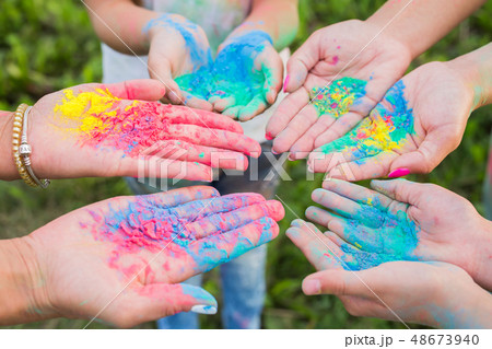 Indian holidays, fun and Holi festival concept - Female palms covered in different colors 48673940