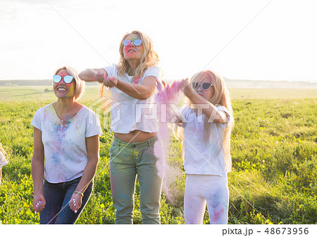 Friendship, Indian holidays and people concept - young women and children dancing on the summer 48673956