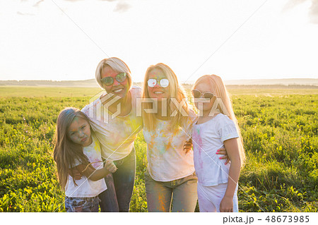 Festival of holi, friendship, happiness and holidays concept - Happy and funny girls covered in Festival of holi, friendship, happiness and holidays concept - Happy and funny girls covered in 48673985