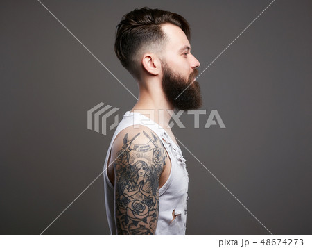 bearded hipster boy in vintage torn dirty shirt bearded hipster boy in vintage torn dirty shirt 48674273