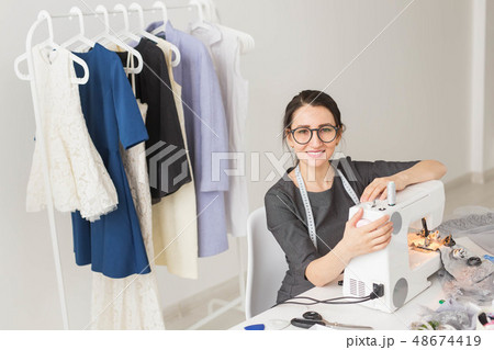 Dressmaker, tailor, works and seamstress concept - High angle view portrait of smiling fashion 48674419