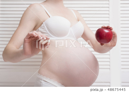 Pregnant woman in underwear holding 48675445