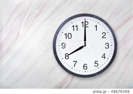 Wall clock show eight o'clock on marble texture. Office clock show 8pm or 8am 48676366