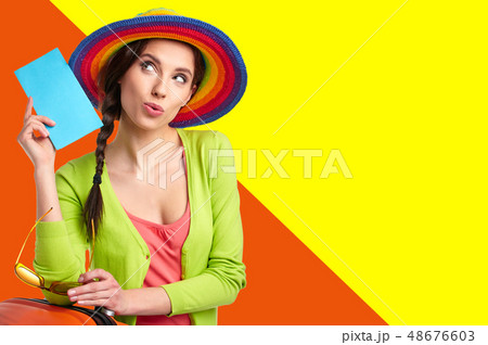 Woman tourist with travel suitcase and blue Woman tourist with travel suitcase and blue 48676603