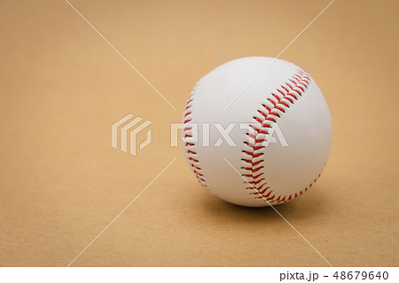Isolated baseball on a brown background and red Isolated baseball on a brown background and red 48679640