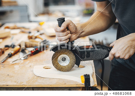 The carpenter works with a tree 48681068