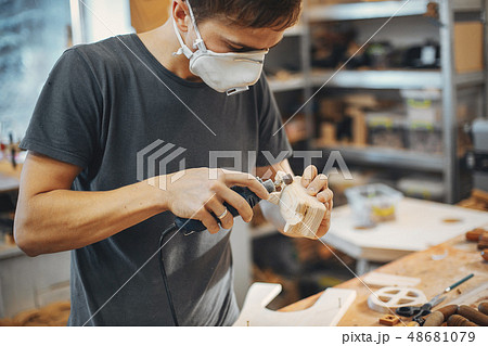 The carpenter works with a tree The carpenter works with a tree 48681079