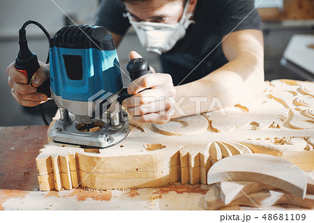 The carpenter works with a tree The carpenter works with a tree 48681109
