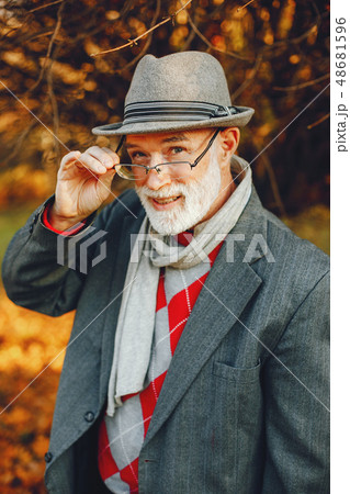 Elegant old man in a sunny autumn park  48681596