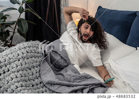 Stressed young man realizing that he is late 48683532