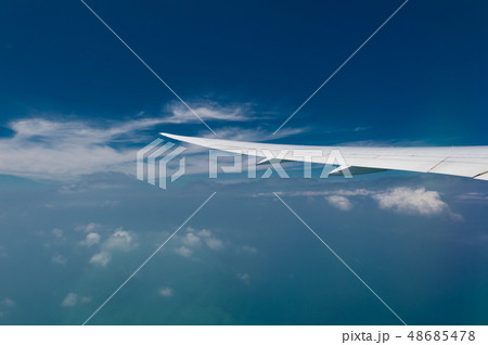 Wing of airplane flying above the clouds in the Wing of airplane flying above the clouds in the 48685478