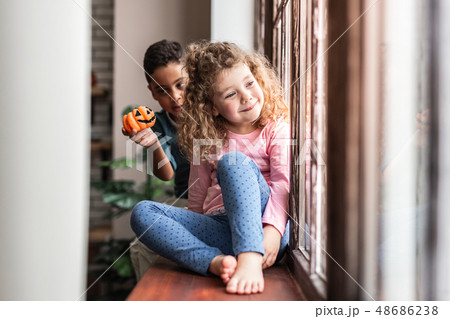 Delighted international boy demonstrating his pumpkin toy 48686238