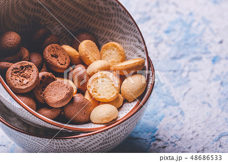 Several sponge biscuits in bowl on light wooden 48686533