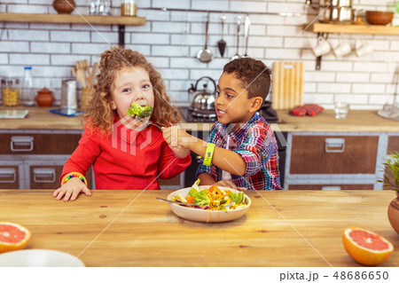 Positive delighted best friends having dinner together 48686650