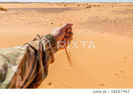 hand pours sand hand pours sand 48687462