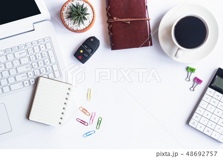 White desk office with laptop, smartphone and othe 48692757