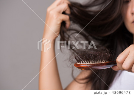 Woman show her brush with long lost hair Woman show her brush with long lost hair 48696478