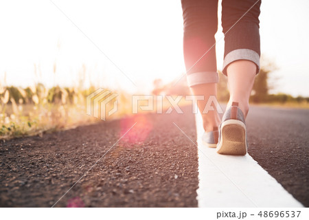 Closeup woman walking towards on the road side 48696537