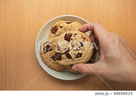 Flat lay background of hand picking up cookies 48698024
