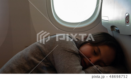 Young tween girl on airplane 48698752
