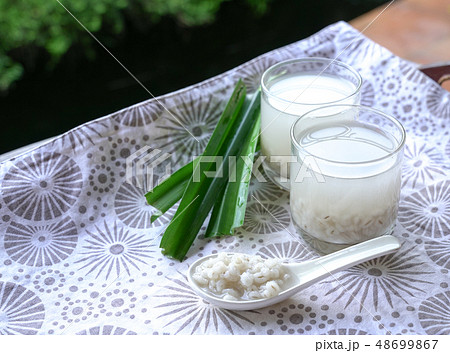 Barley water in glass and cooked pearly barley Barley water in glass and cooked pearly barley 48699867