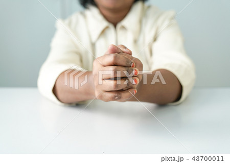 Both hands clasping 48700011