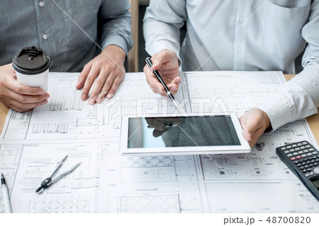Team of engineering or architect meeting and discussing on bluep Team of engineering or architect meeting and discussing on bluep 48700820