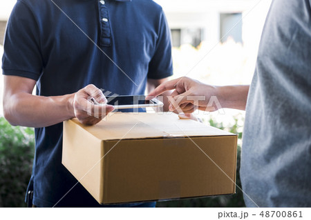Delivery mail man giving parcel box to recipient, Young man appe 48700861