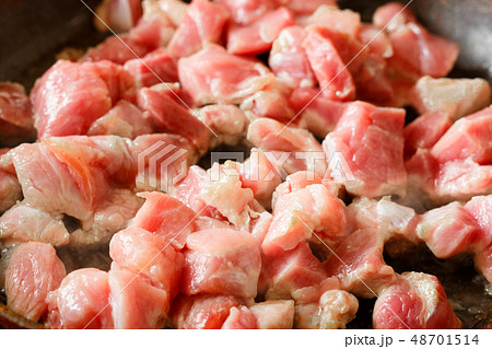 Pieces, cubes of fresh pink meat fried in a 48701514