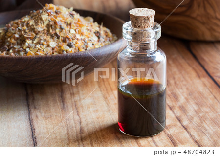 A bottle of myrrh essential oil with myrrh resin 48704823