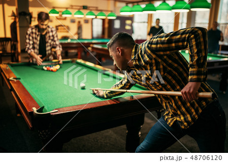 Two male billiard players with cue at the table 48706120