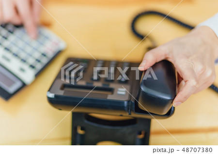 Close-up of the workplace is occupied by the office phone. The technology of digital connection of 48707380