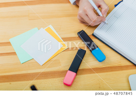 Office table with accessories: a marker of blue and pink colors, a pen, a pen, a pencil, a notebook Office table with accessories: a marker of blue and pink colors, a pen, a pen, a pencil, a notebook 48707845