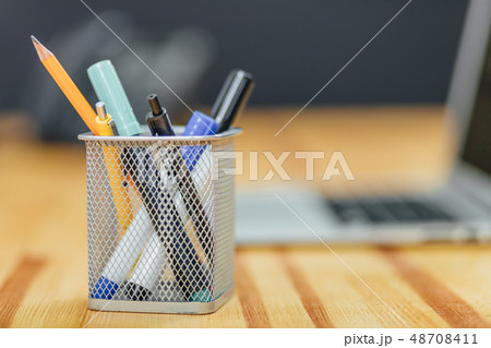 Counters, pens with different colored stickers on a wooden table. Manager's job. Different 48708411