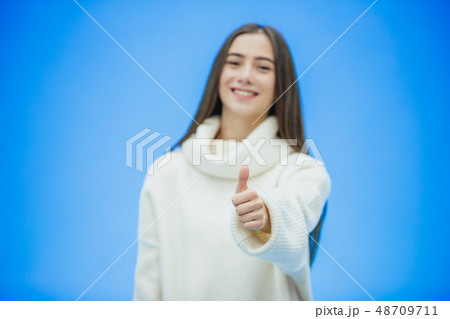 Portrait of a young girl business. High girl on a blue background. During this time she is dressed 48709711